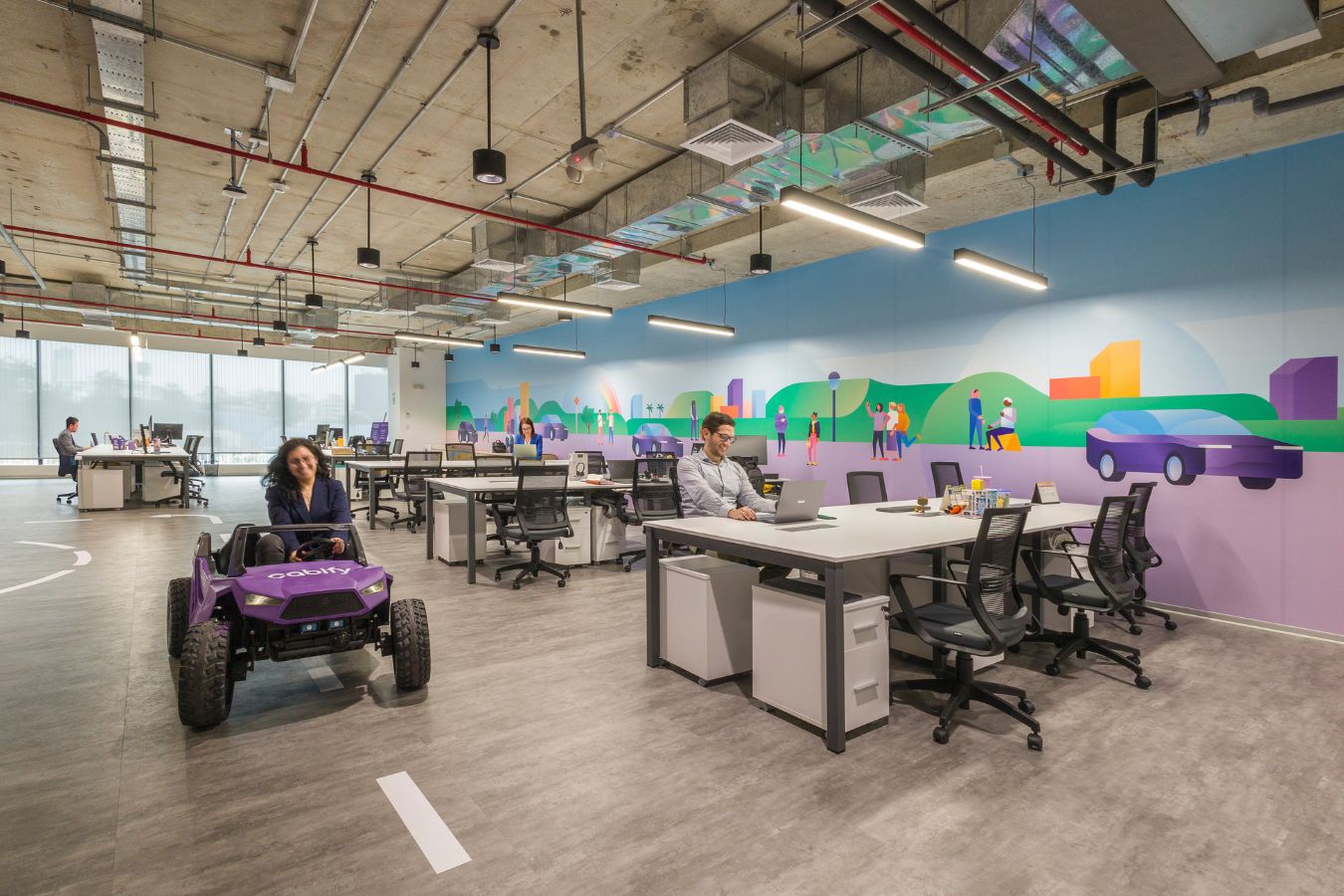 Cabify Offices - Open plan workspace featuring floor road markings and industrial ceiling - Contract Workplaces.jpg